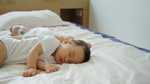 Two twin babies enjoying their midday nap