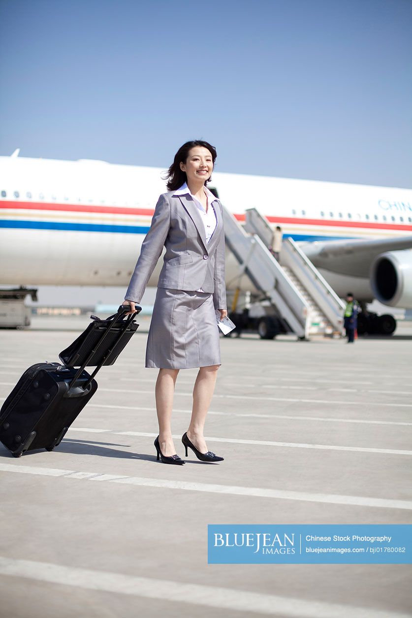 Chinese businesswoman on the airplane runway