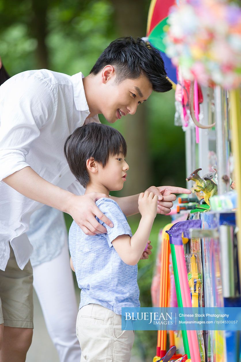 Chinese father and son buying toys