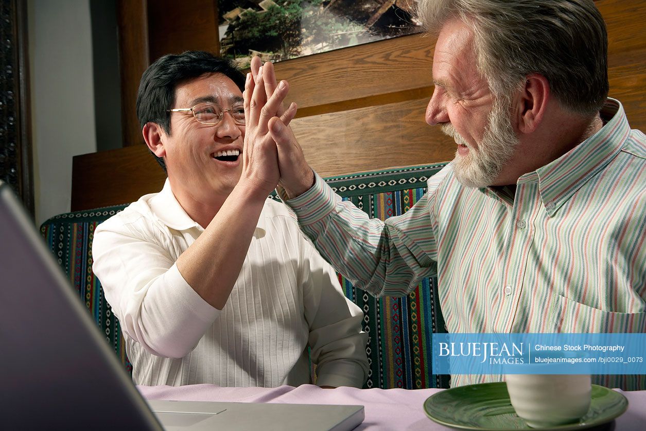 Men High-Fiving Each Other