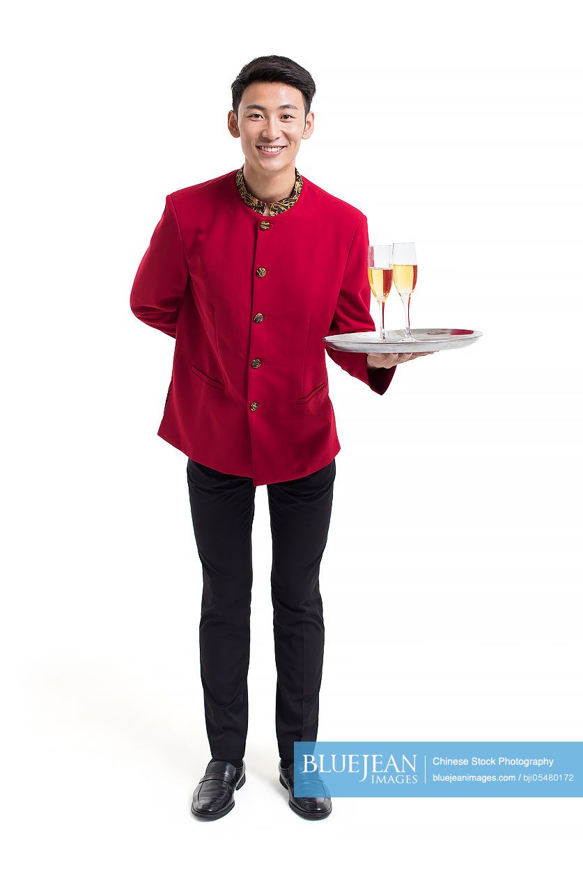 Young Chinese waiter with champagne