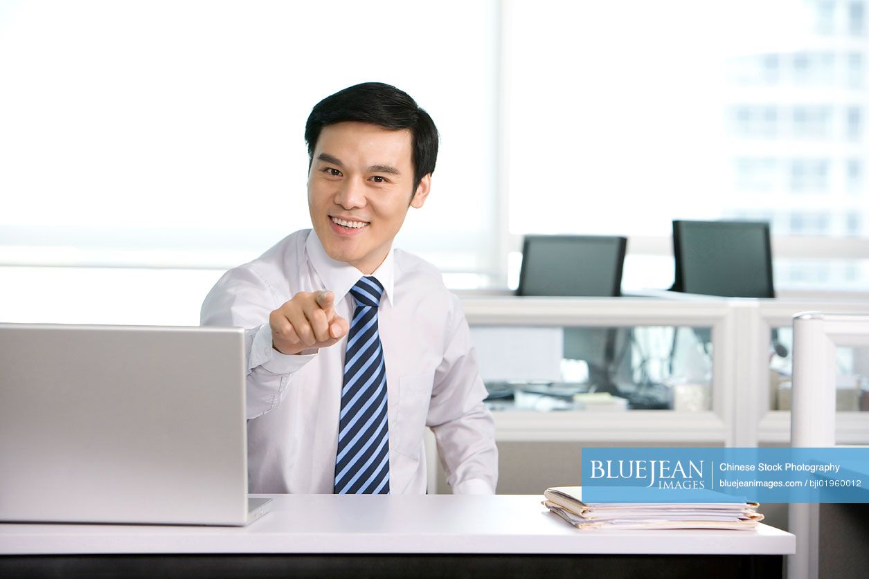 Chinese office worker at his desk