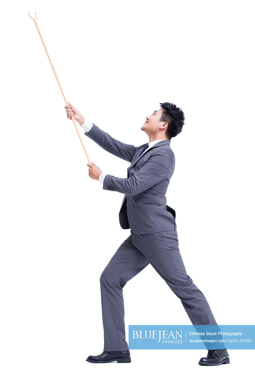 Chinese businessman with pole in hand