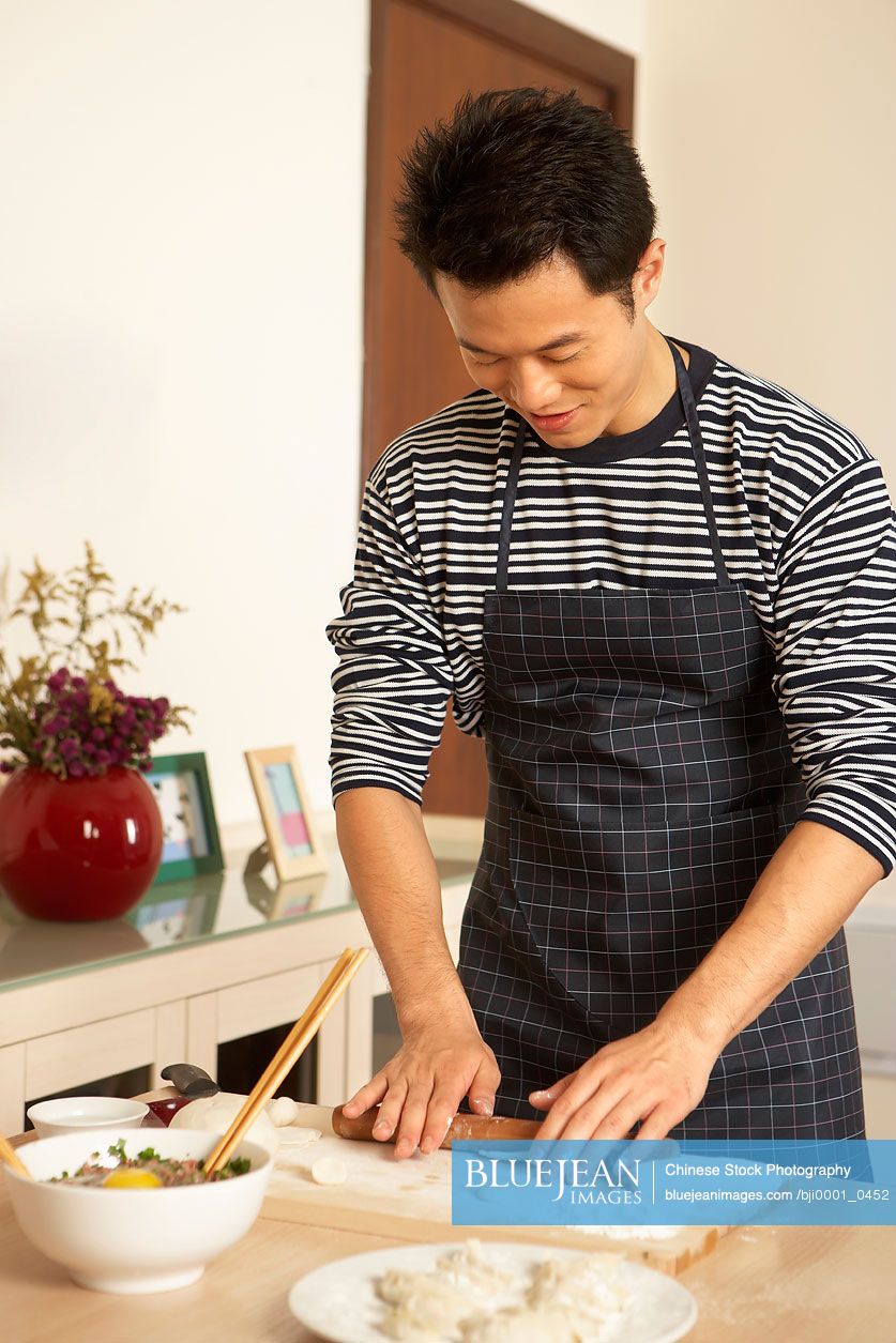 Young Man Preparing Traditional Chinese Food