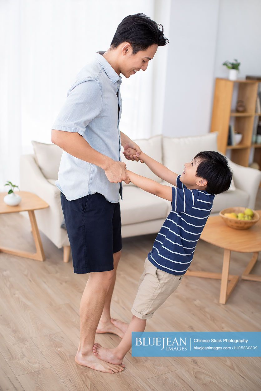 Chinese father and son playing in living room
