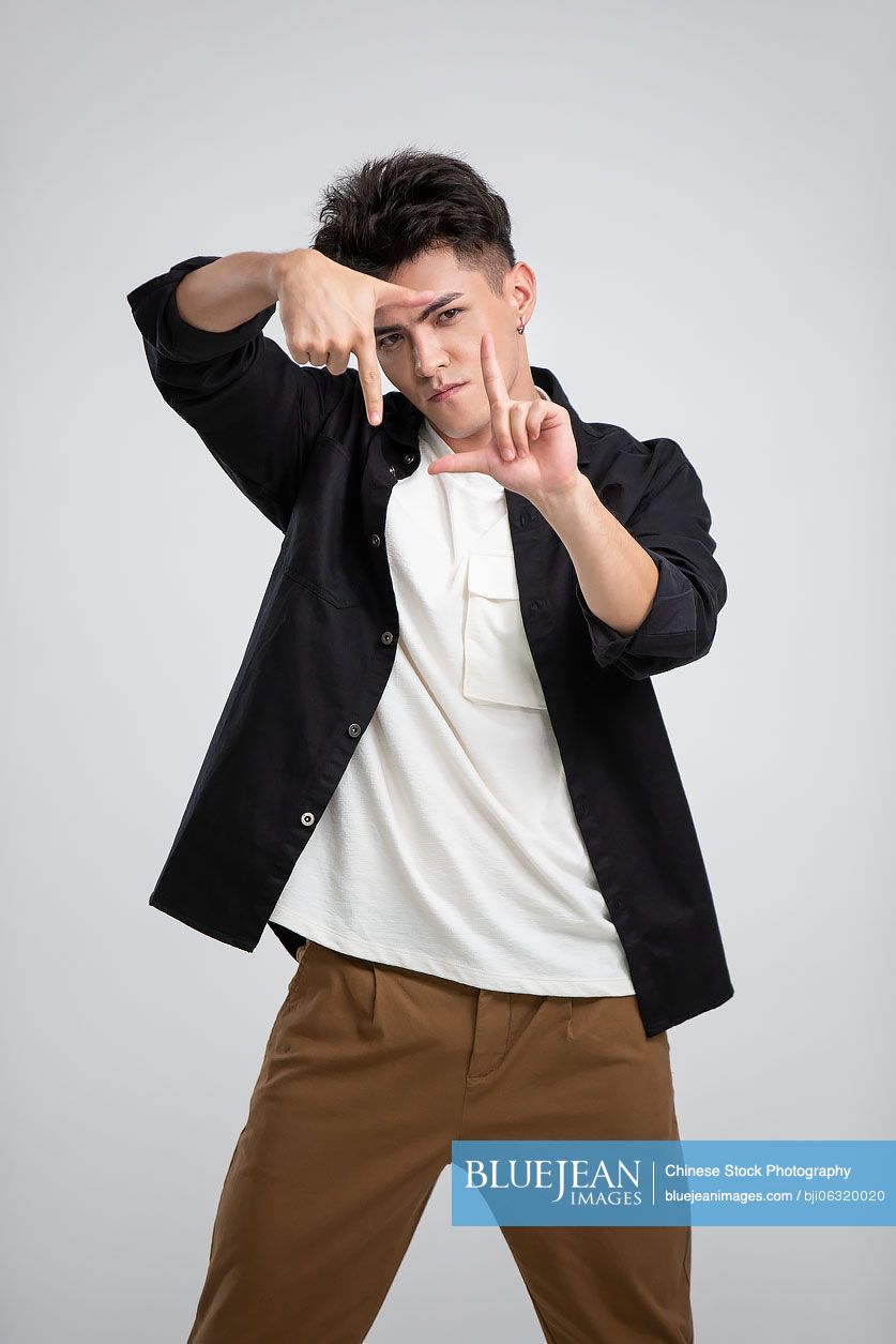 Young Chinese man making finger frame