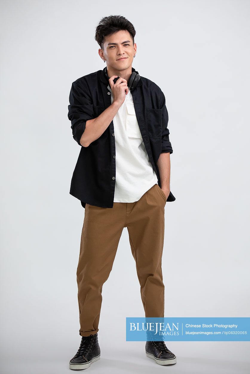 Cool young Chinese man wearing headphones