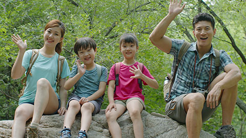 Happy young Chinese family hiking outdoors,4K