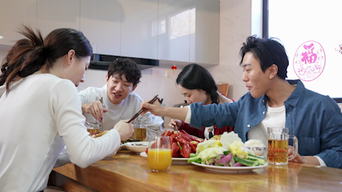 Young friends gathered around the table for a meal