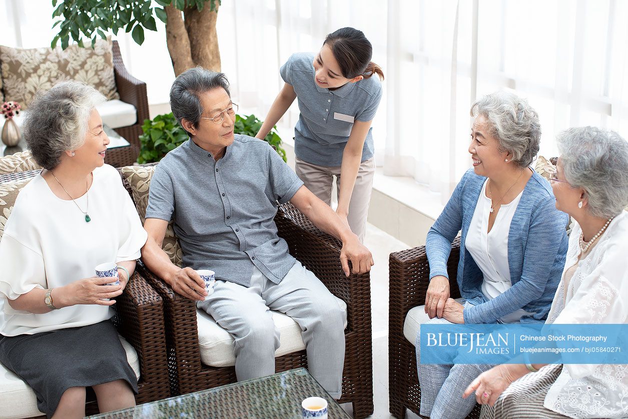Senior Chinese friends talking in nursing home