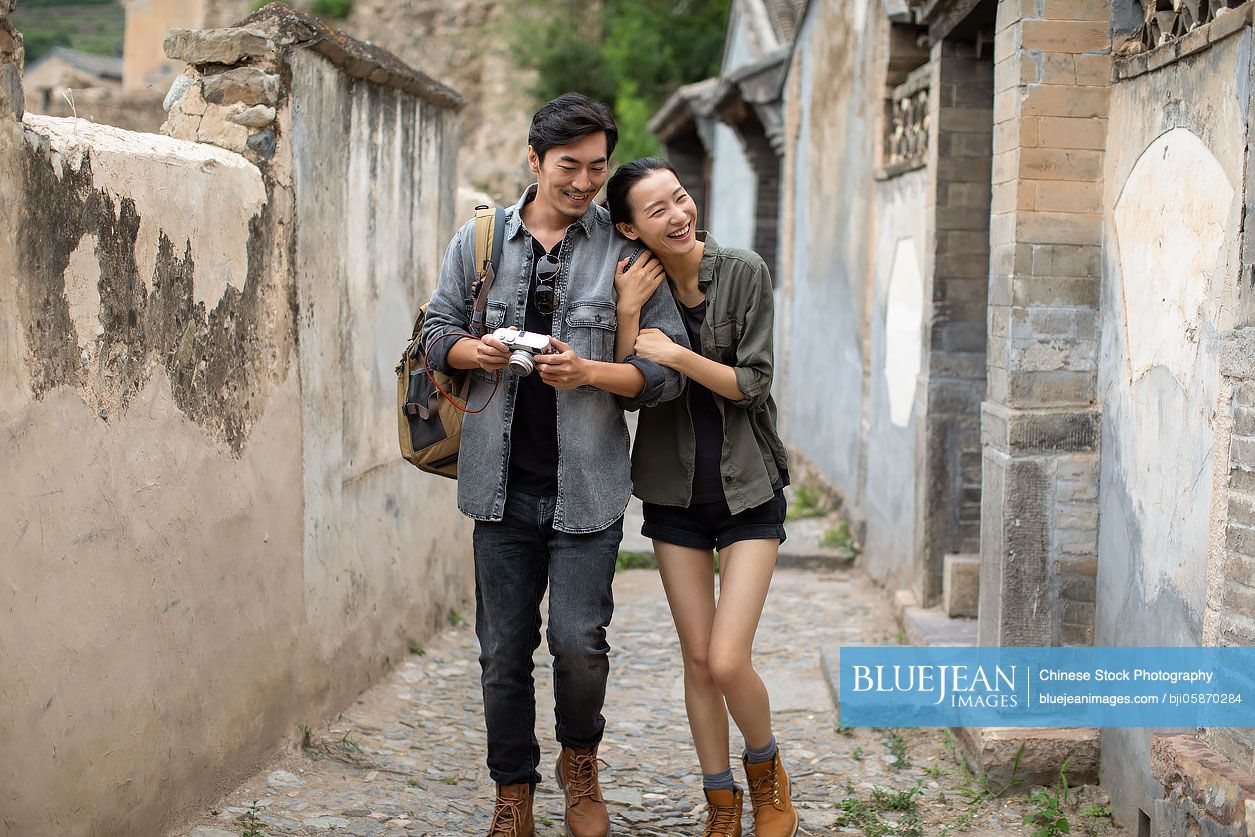 Young Chinese couple walking in village