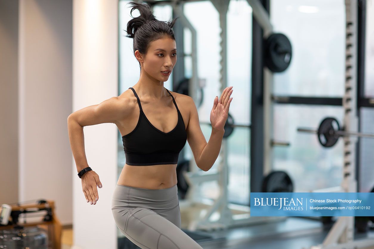 Young Chinese woman exercising at gym