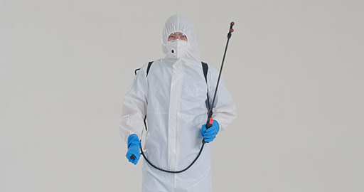 Young Chinese doctor in protective suit using crop sprayer,4K