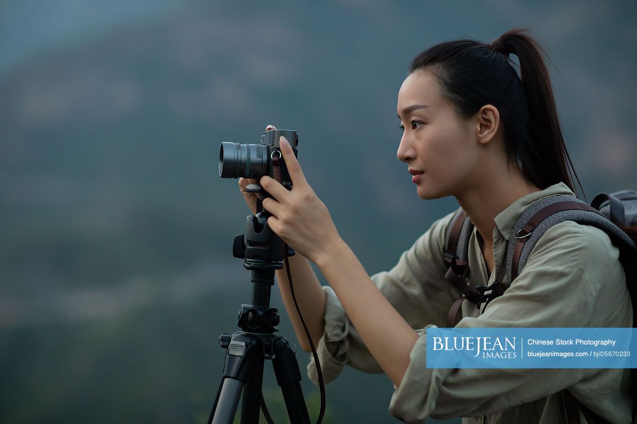Chinese photographer taking photos outdoors
