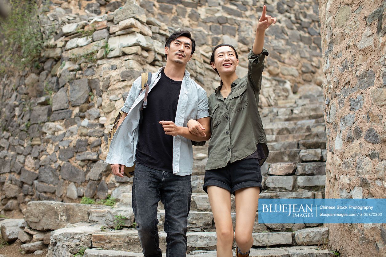 Young Chinese couple hiking in village