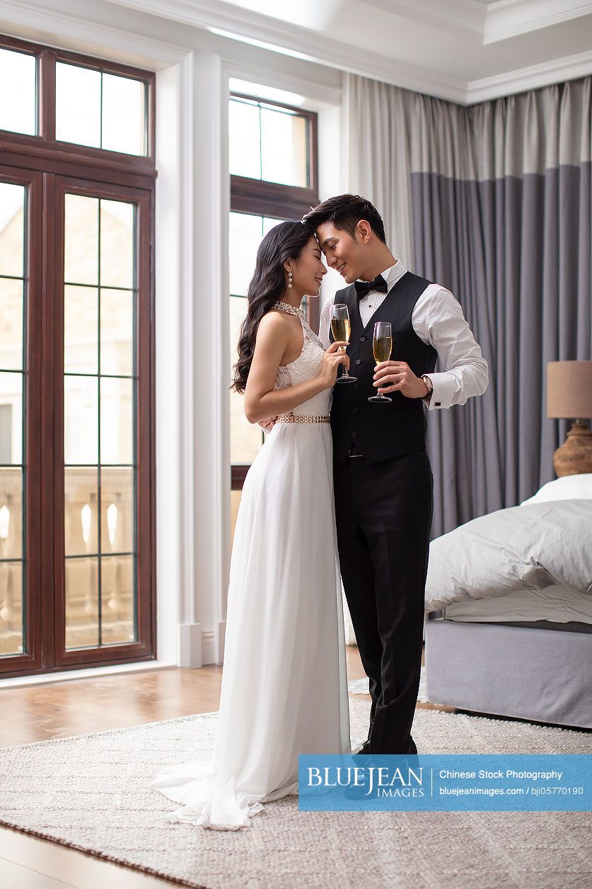 Happy young Chinese couple enjoying their love at home