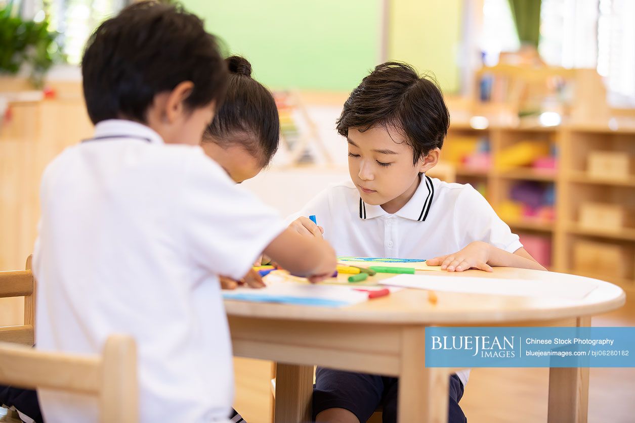 Chinese children painting in classroom