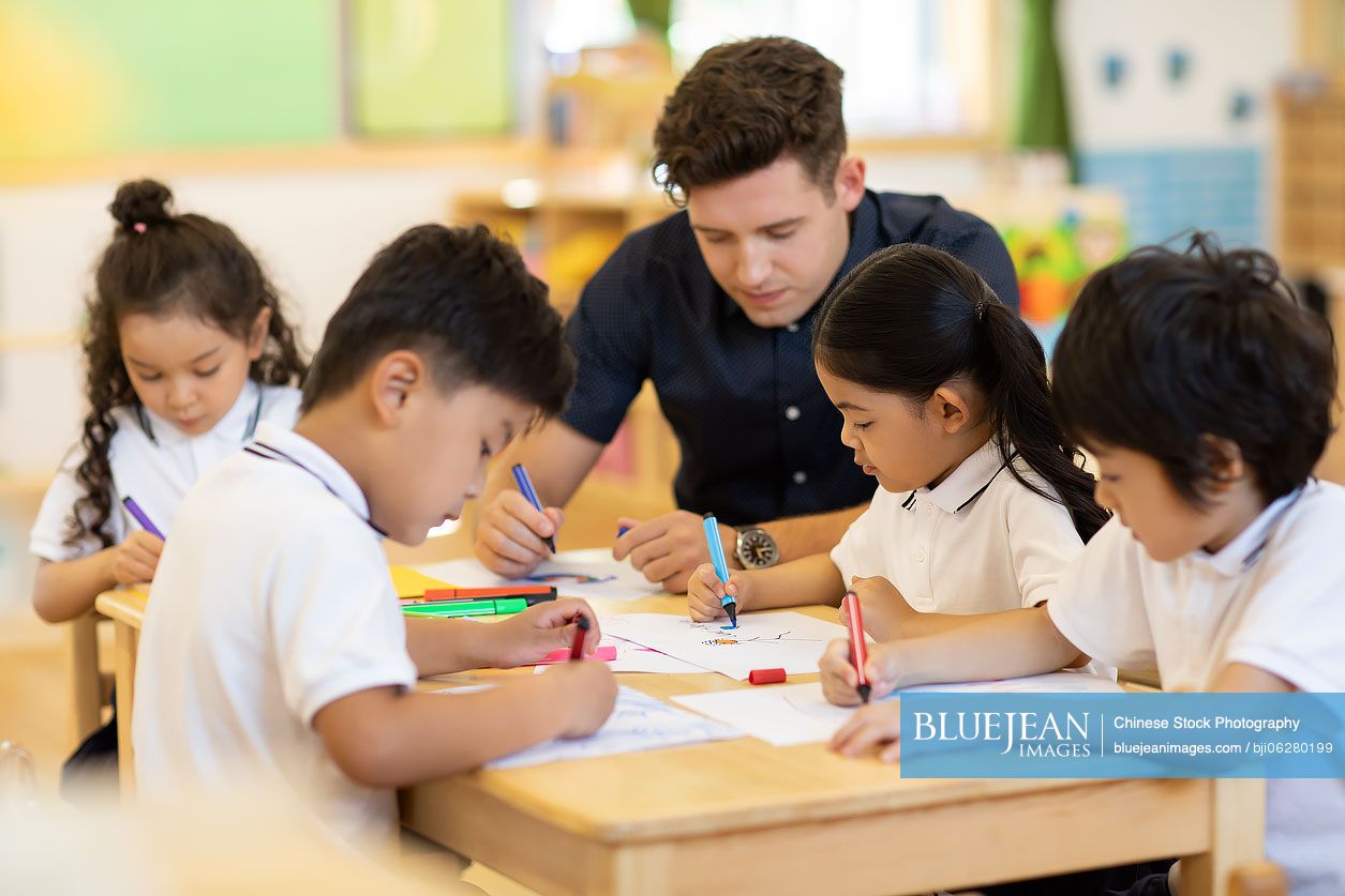 Foreign teacher teaching art class in classroom