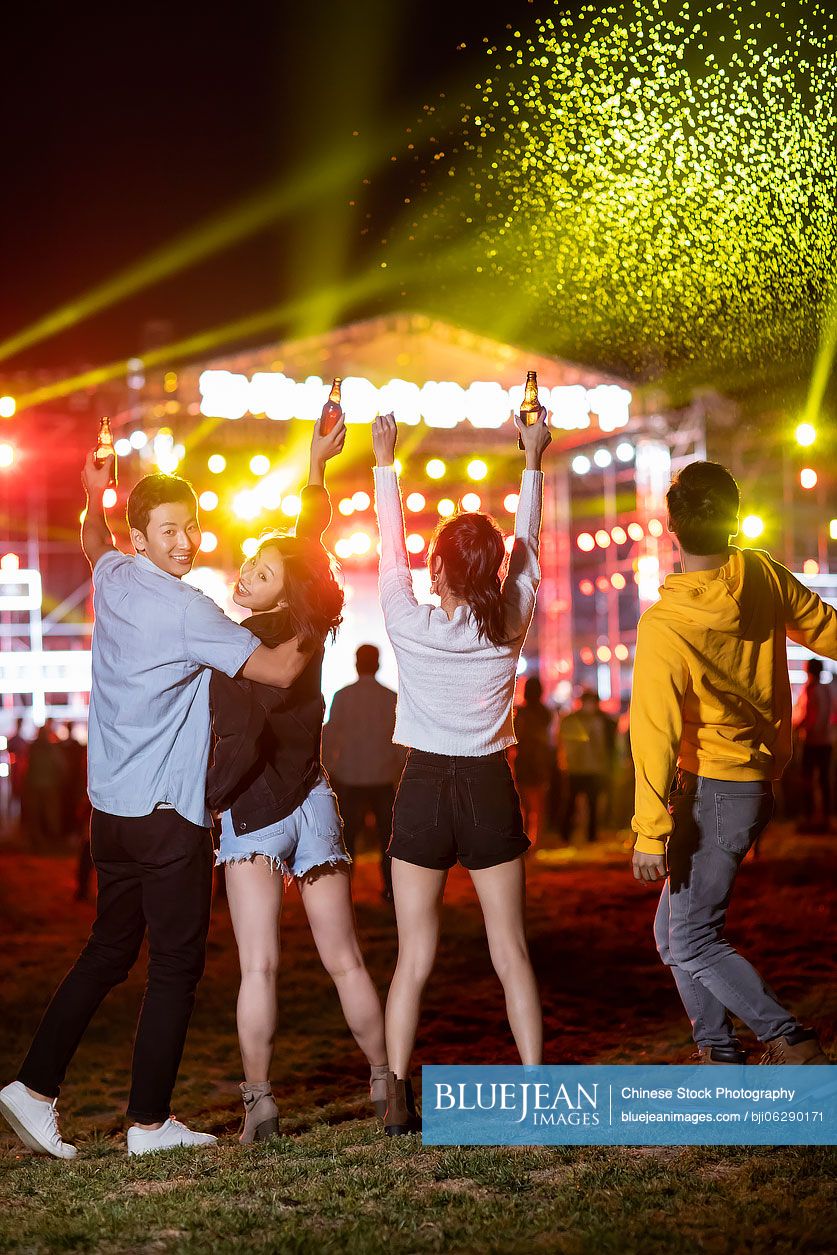 Happy young Chinese friends at music festival
