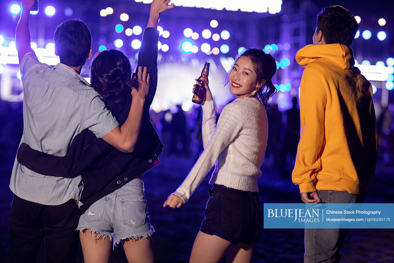 Happy young Chinese friends at music festival
