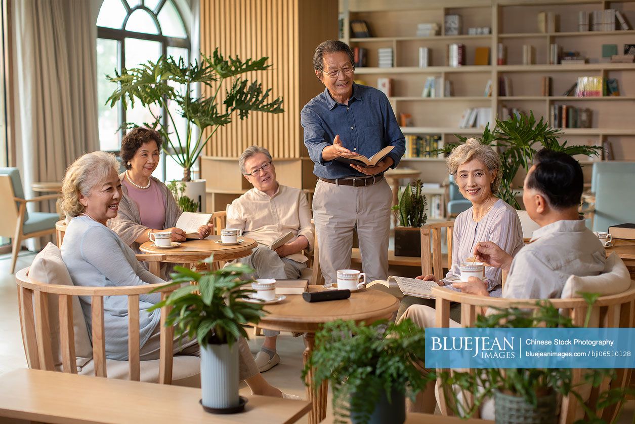 Senior Chinese adult discussing a book in book club