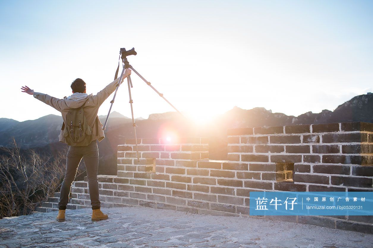 Young Chinese man photographing on the Great Wall