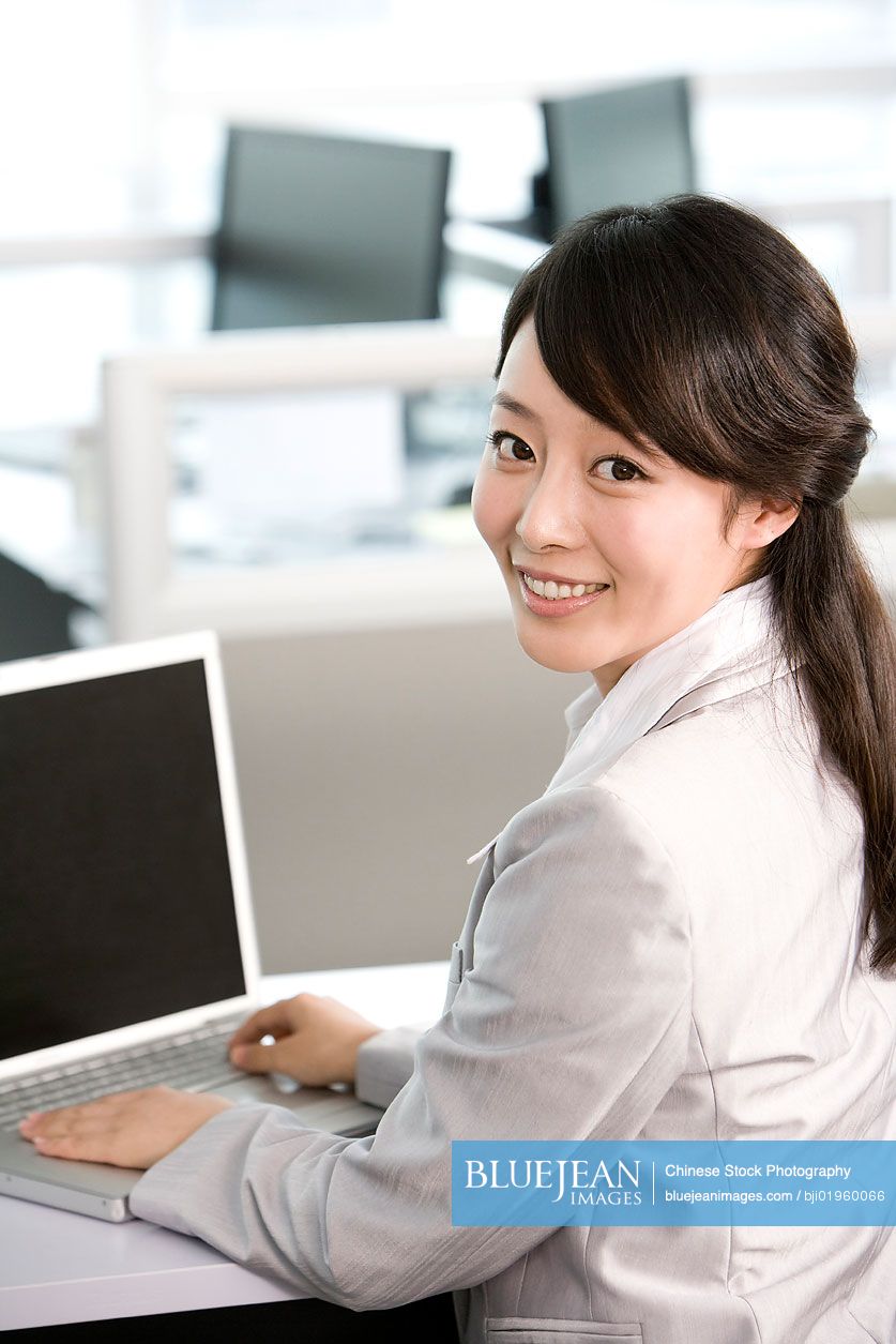 Chinese office worker at her desk