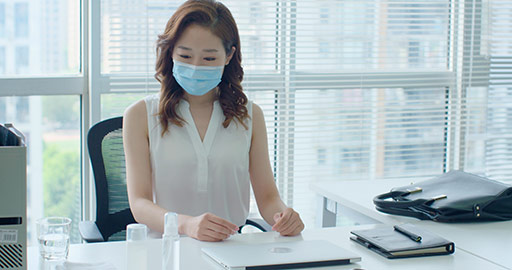 Young Chinese businesswoman with surgical mask coming to work,4K