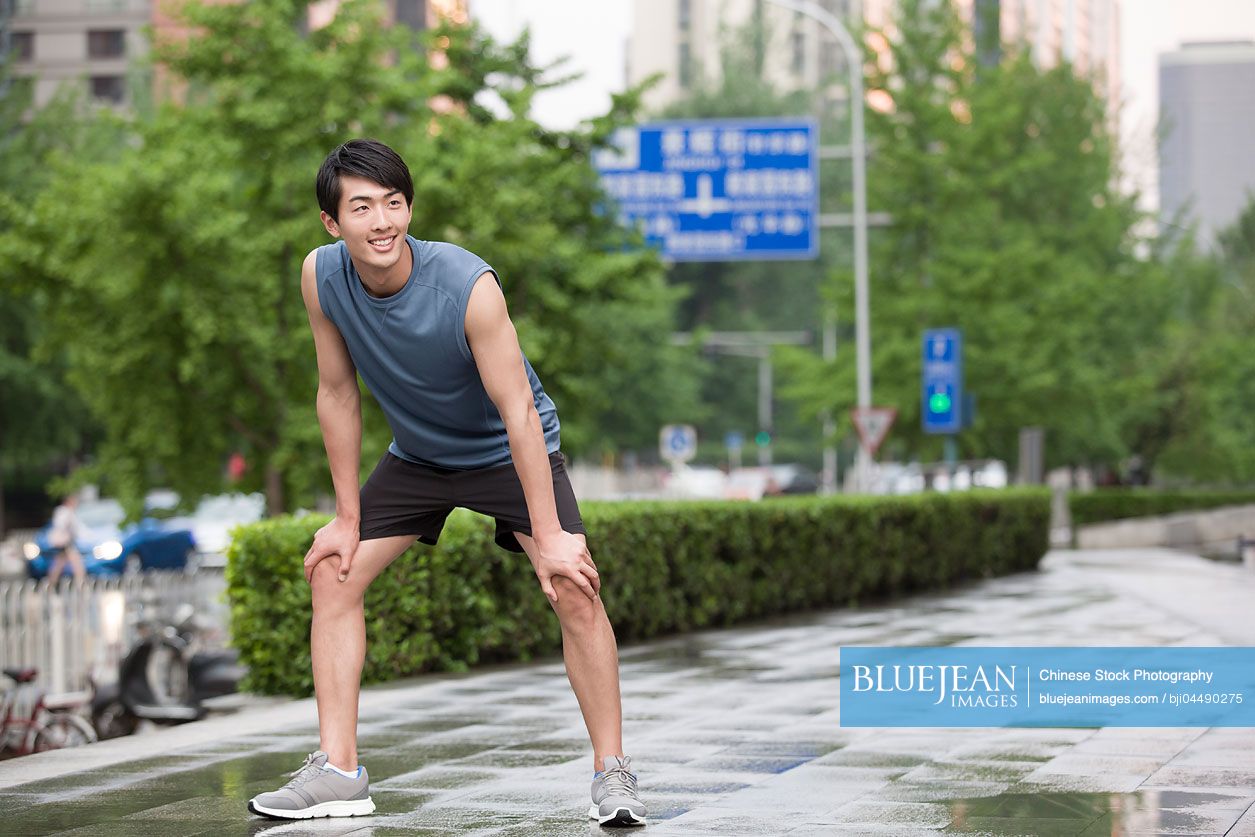 Young Chinese man taking a break from exercise