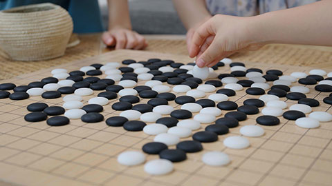 Family enjoying a game of Go in the hotel room