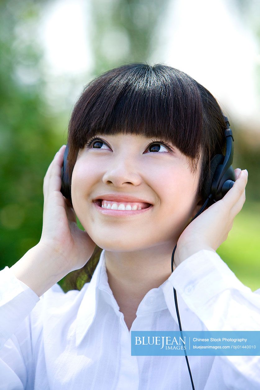 Chinese woman in park with headset