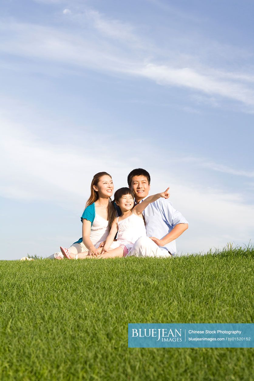 Chinese family sitting on the grass