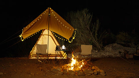 Illuminated tent and campfire