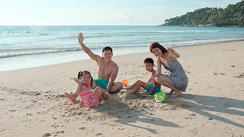 Happy young Chinese family having fun on beach,4K