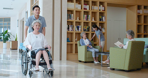 Young Chinese nursing assistants taking care of senior people in nursing home,4K