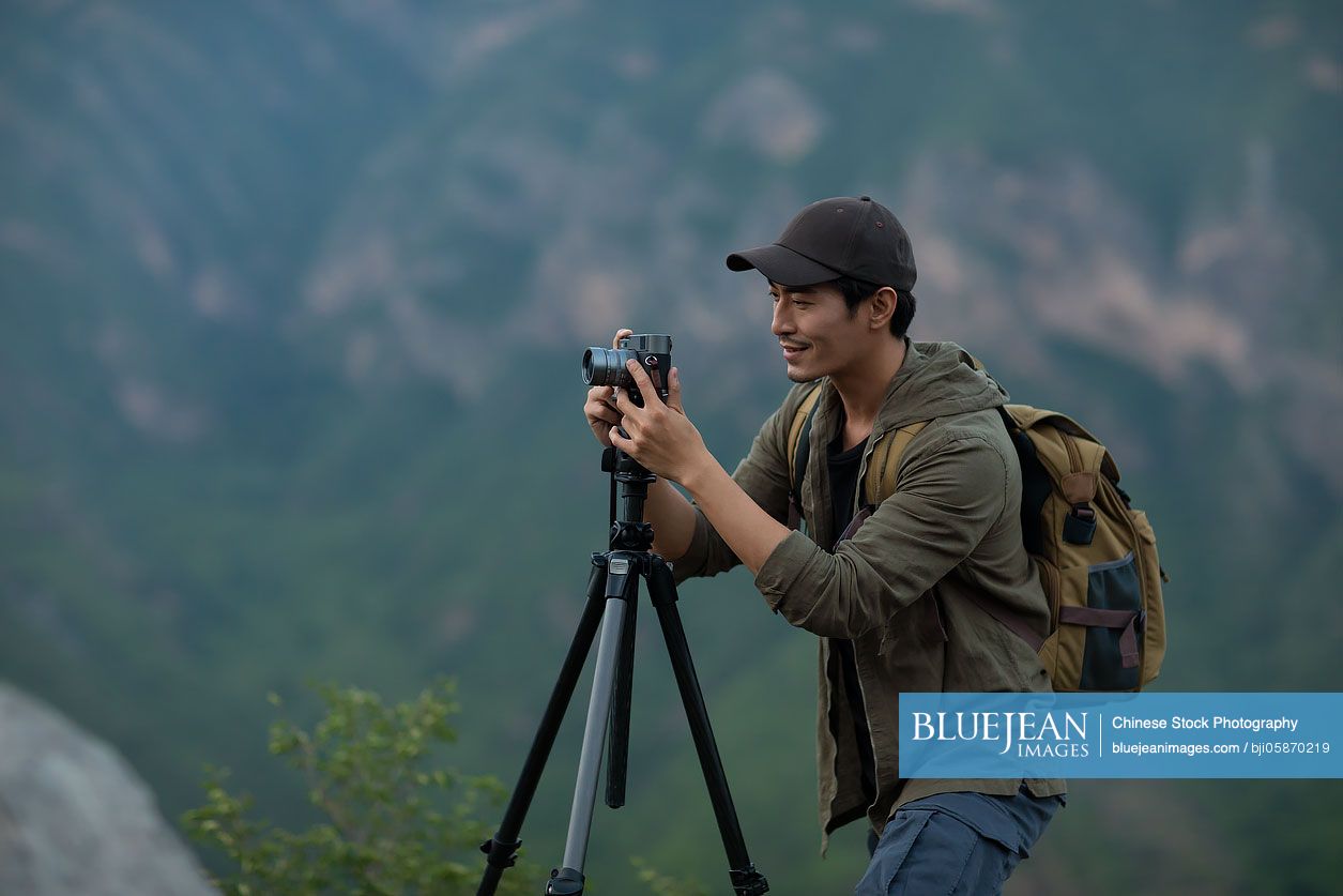 Chinese photographer taking photos outdoors