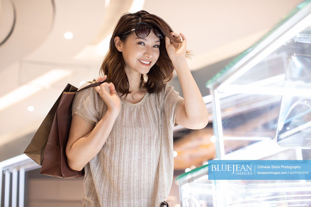 Elegant Chinese woman shopping in shopping mall