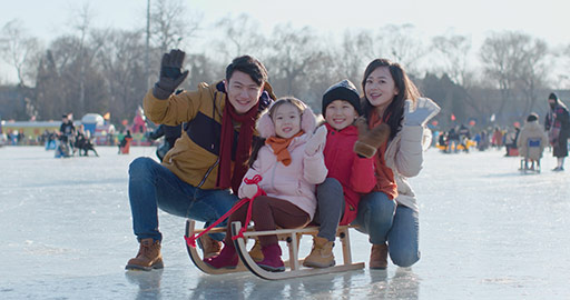 Happy young Chinese family waving on ice,4K