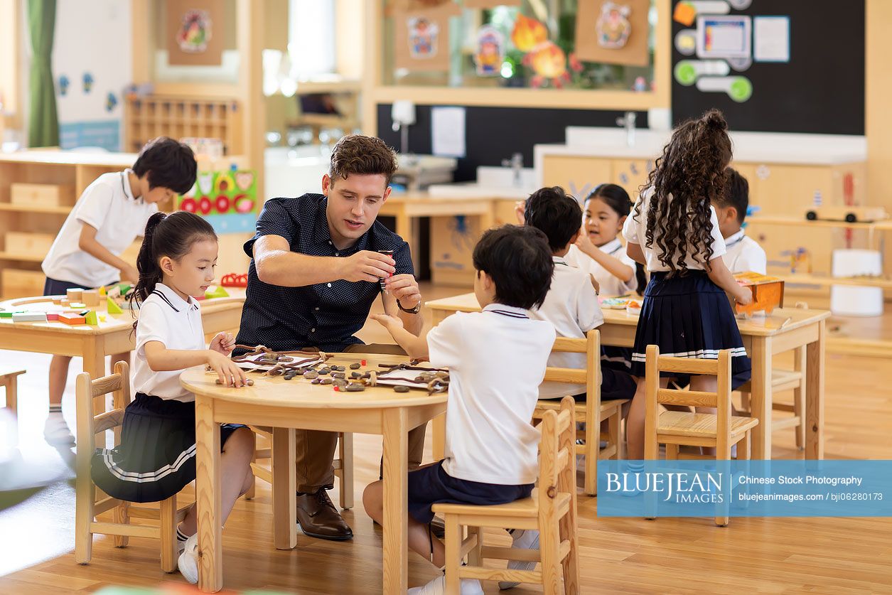 Foreign teacher teaching art class in classroom