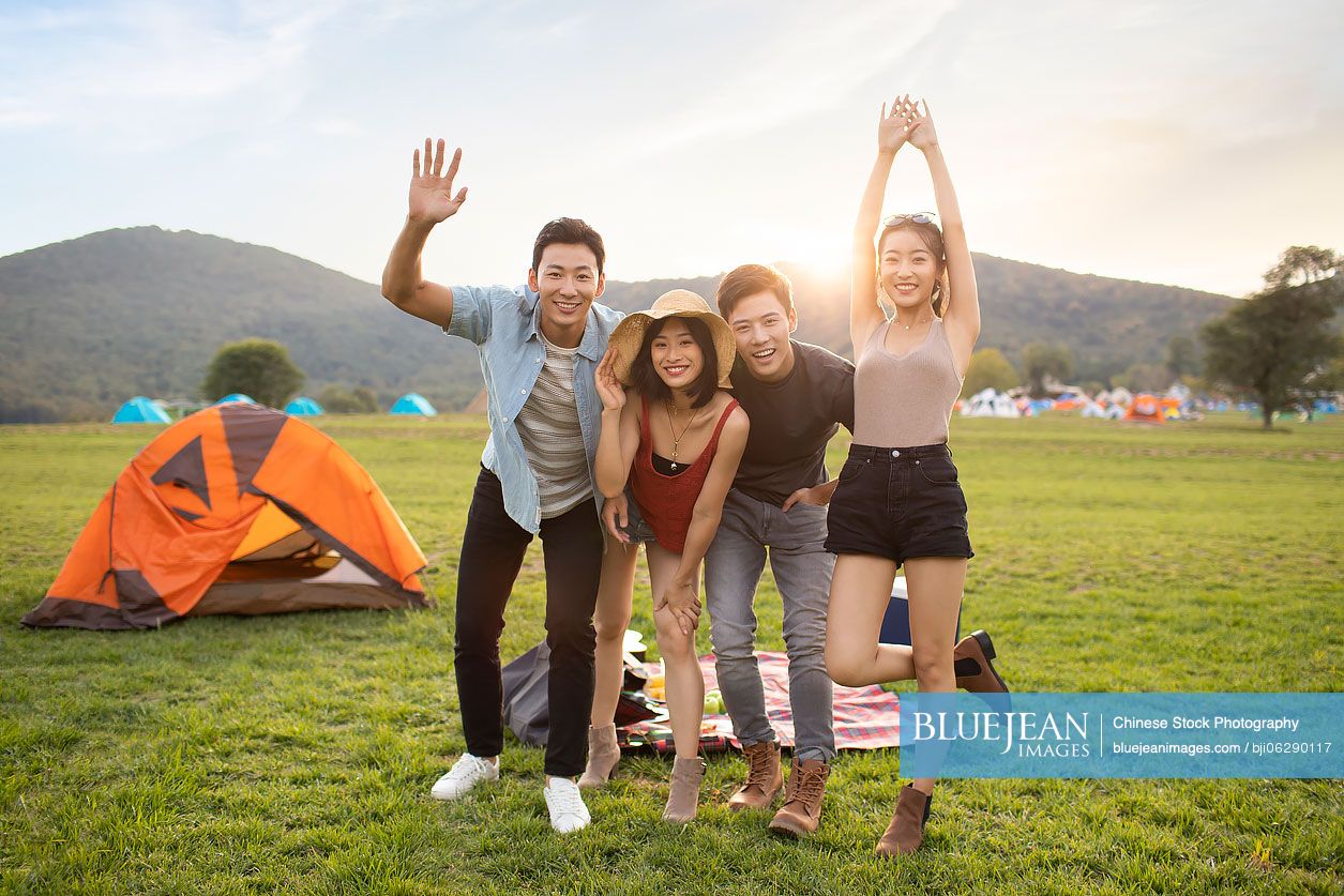 Happy young Chinese friends having a picnic outdoors