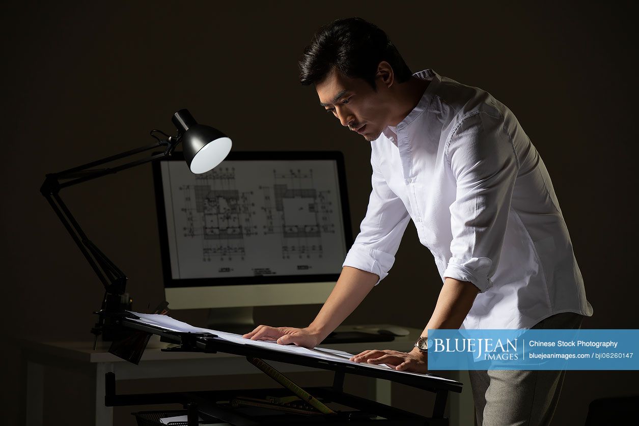 Chinese designer working on construction planHighres stock photo for