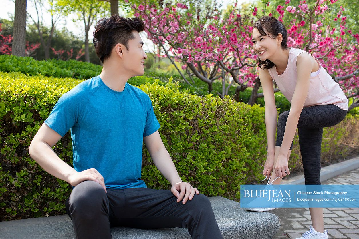 Happy young Chinese couple preparing for morning run