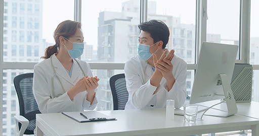 Young Chinese doctors using hand sanitizer in doctor's office,4K