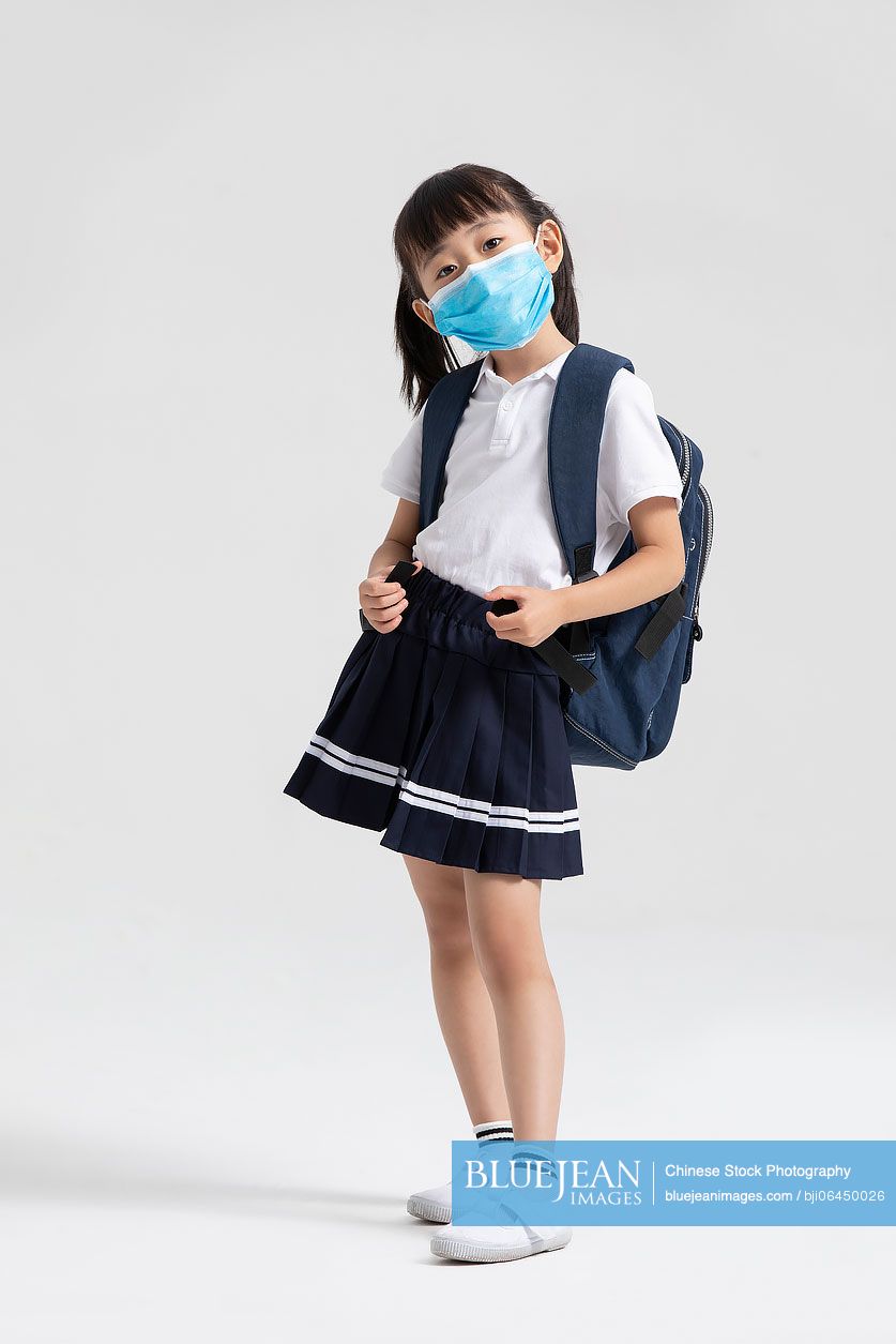 Little Chinese girl wearing surgical mask