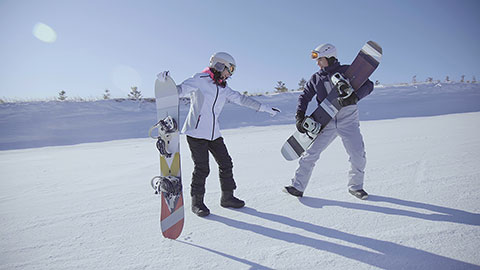 Young Chinese couple with snowboards on the snow,4K