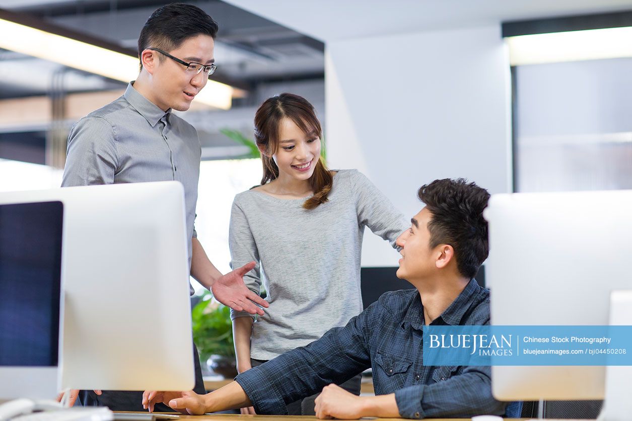 Chinese IT workers talking in office