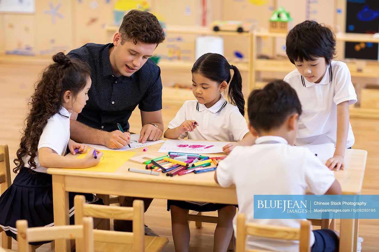 Foreign teacher teaching art class in classroom