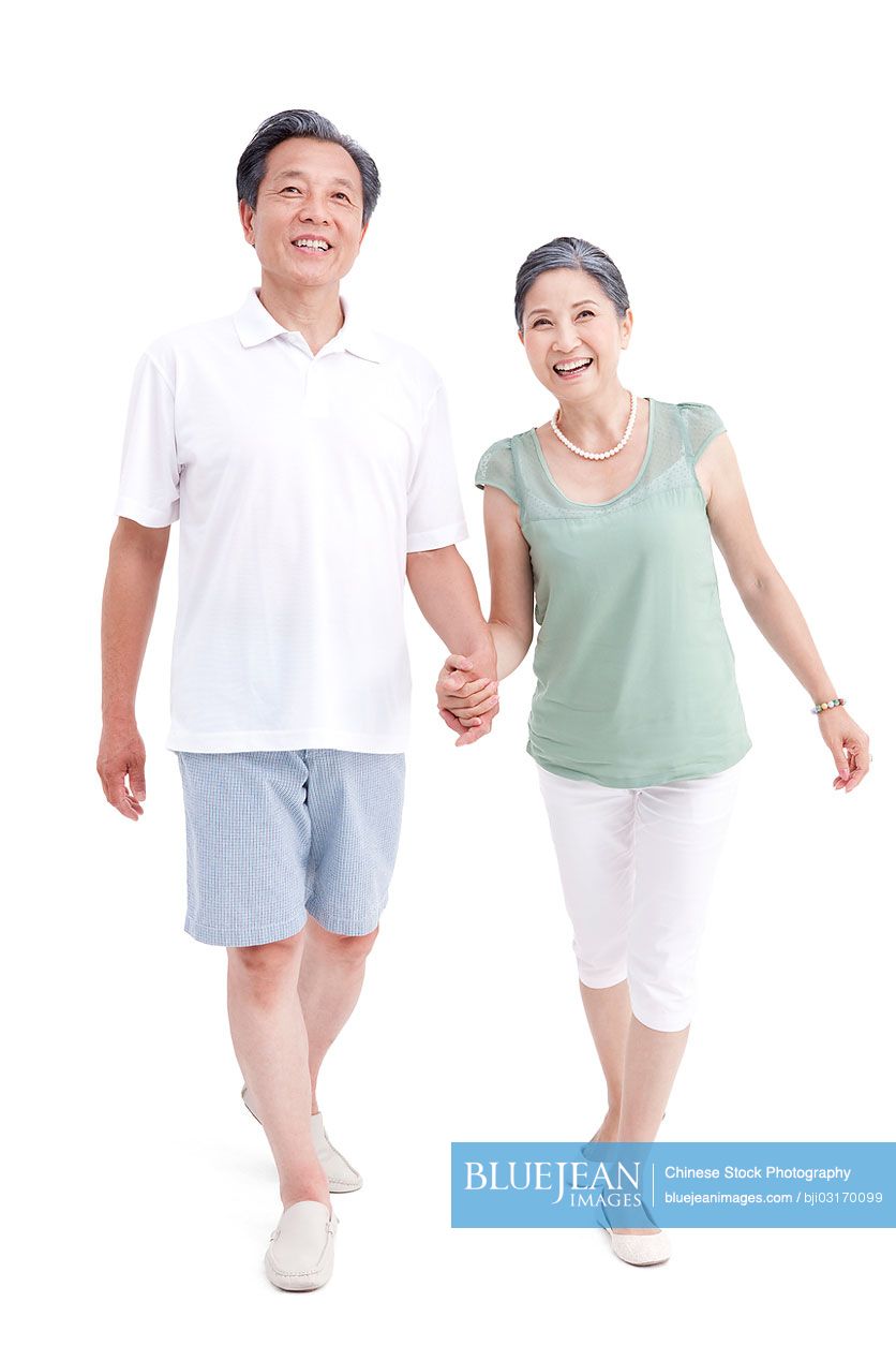 Happy senior Chinese couple holding hands