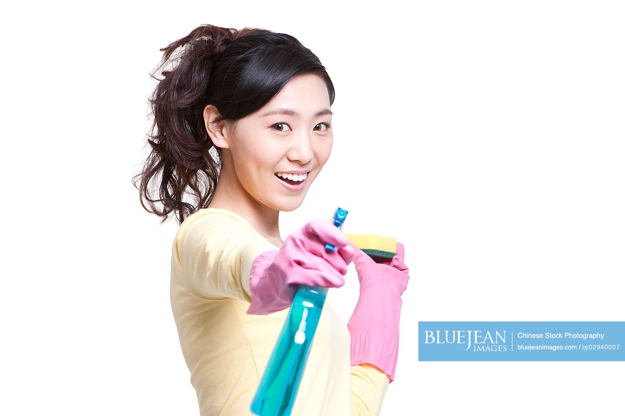Chinese housewife with cleaning product
