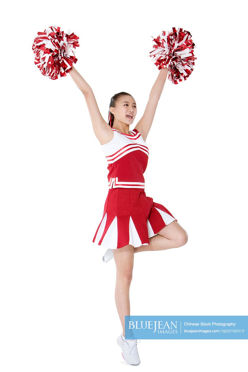 Chinese cheerleader in action with her pom-poms